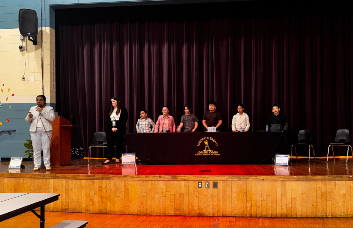  the principal, social worker, and 6 students standing on stage